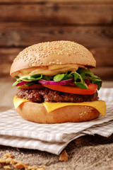 Closeup of home made burger on wooden background