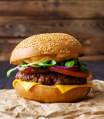 Closeup of home made burger on wooden background