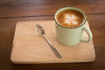 Hot art Latte Coffee in a cup on wooden table