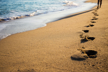 close up of footprints on the beach