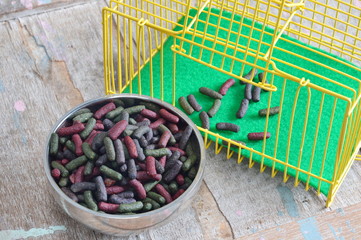 rabbit food on stainless bowl and yellow cage