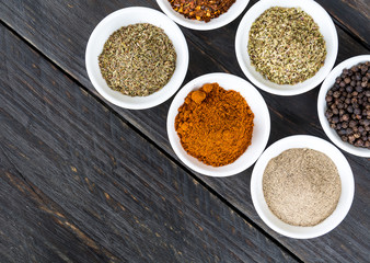 Spices and herbs in  bowls.