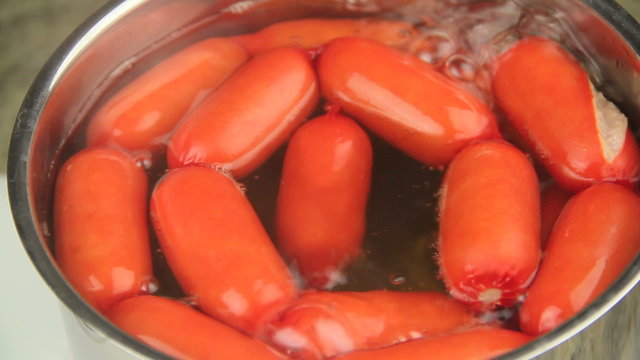 Australian frankfurters called cheerios cooking in a pot of boiling water. 
