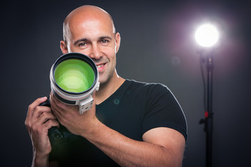 Young, pro male photographer in his studio during a photo shoot