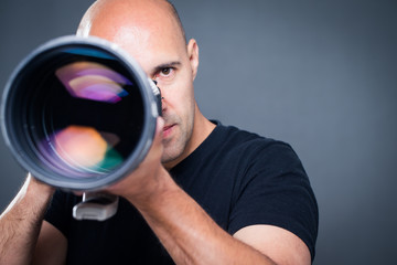 Young, pro male photographer in his studio during a photo shoot