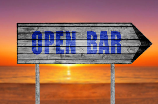 Open Bar wooden sign with on a beach background