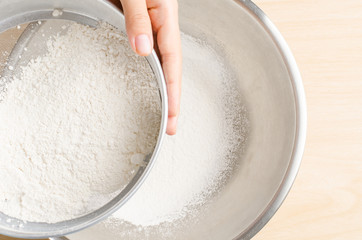 Sifting flour into the bowl,food ingredient,prepare for cooking or baking