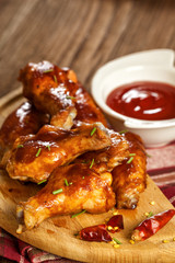 Chicken wings on wooden background with bbq sauce