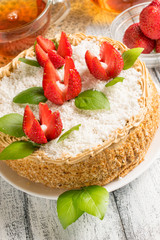 Celebratory cake with strawberry flowers and tea