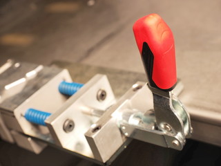 Red plastic lever of an industrial mechanical clamping device, Melbourne 2015