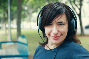 Beautiful  Woman with Headphones Outdoors