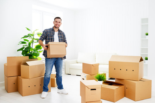 moving to a new apartment. happy man with cardboard boxes