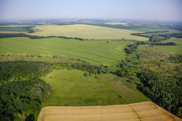 Fototapeta na wymiar aerial view above the green fields