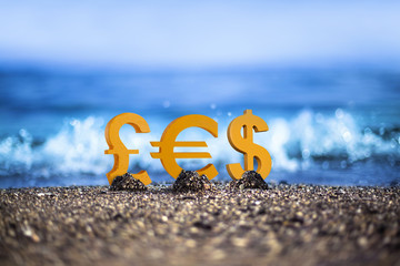 Pound, Euro and Dollar currency icons are standing on the wavy sea side