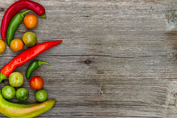 tomatos and peppers, vegetables, still life in wooden background