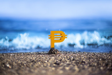 Russian Ruble currency icon is standing on the wavy sea side