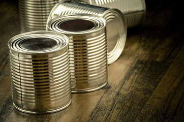 Tin cans for food on wooden background, Selective focus and color effect