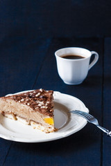 Piece of coffee mousse on the ceramic plate with fork