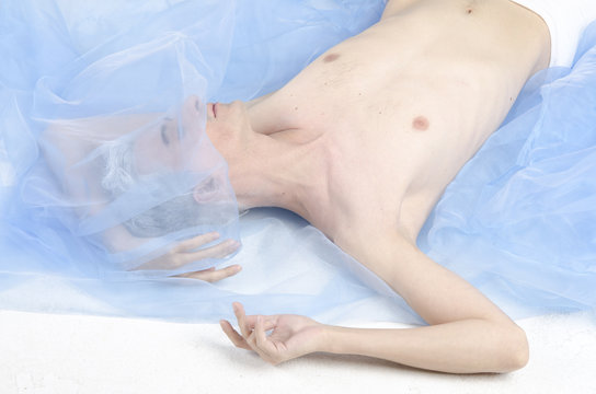 a fallen angel on a blue blanket. 