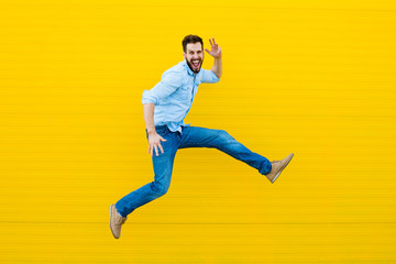 men jumping on yellow background