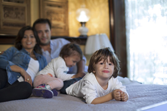 Happy family is spending good time on bed