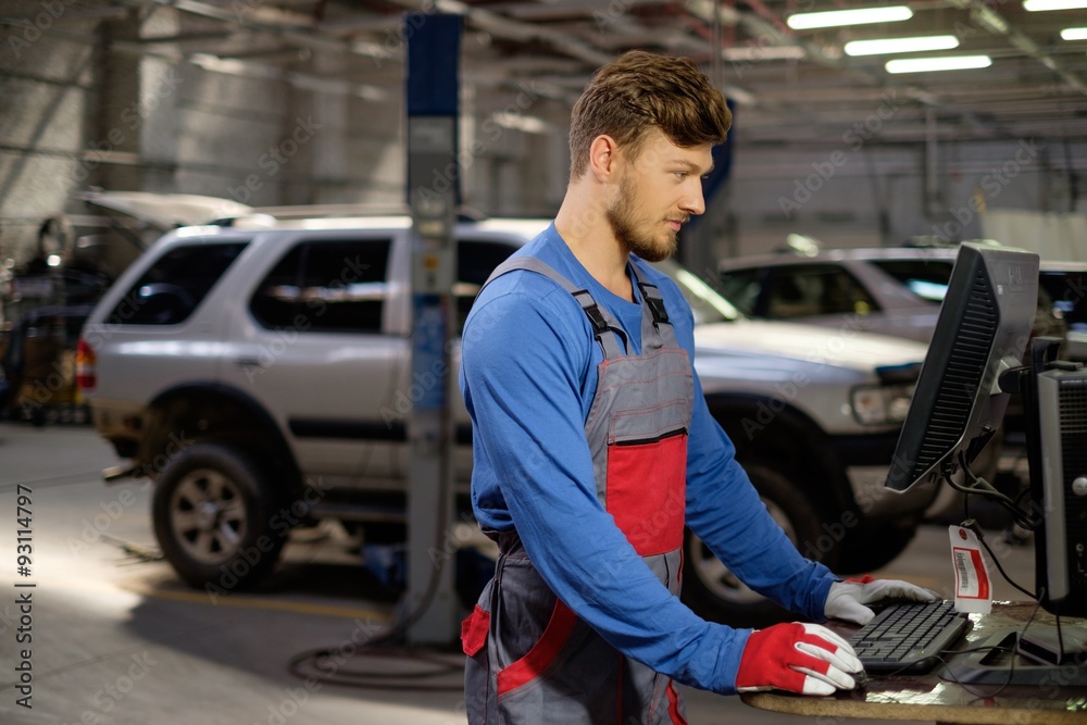 Sticker Specialist near car diagnostic pc in a workshop