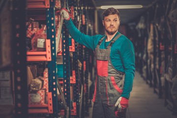 Worker on a automotive spare parts warehouse