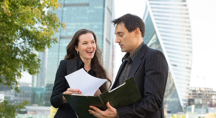 Two business people looking at papers