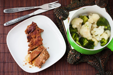 homemade food. Meat steamed with cauliflower and broccoli, top