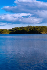 Lake summer view with reflection of clouds on water, Finland, Europe