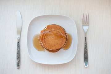 Stack of pancakes with  maple syrup, top view