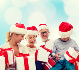 happy family in santa helper hats with gift boxes