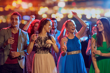 happy friends with champagne dancing at nightclub - obrazy, fototapety, plakaty