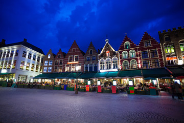 Grote Markt square with market at night in Bruges