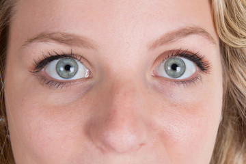 Close-up on beautiful blue eyes of a young woman