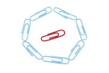 Circle of blue paper clips surrounding one red paper clip. Focus is on red paper clip.