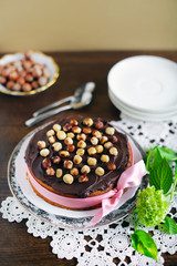 Hazelnut and chocolate cake with pink ribbon, present