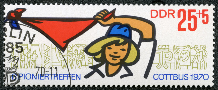 GDR - 1970: Pioneer Girl Holding and Waving Kerchief and Pioneer Activities