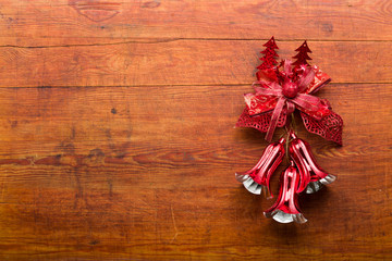 Bells and red loop on wooden background