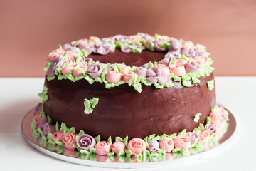 Homemade chocolate cake with colorful cream flowers