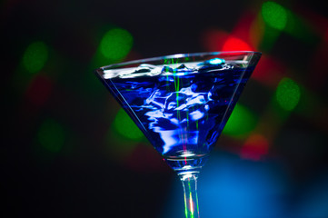 Fire blowing out of blue lagoon glass/close-up with black backgr