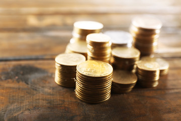 Stack of coins on wooden background