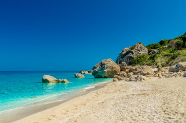 Obraz premium Megali Petra Beach, Lefkada Island, Levkas, Lefkas, Ionian sea. Wild beach of Megali Petra. A beautiful beach with large rocks in the water.