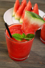 Glass of watermelon juice on wooden table, closeup