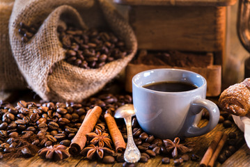 Breakfast with croissant and coffee on wooden table