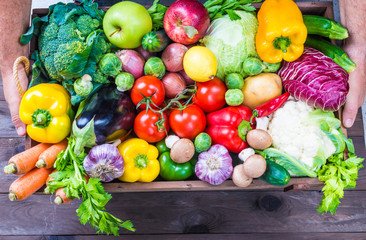 Vegetables and fruits in wood box delivery background.