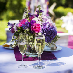 bridal bouquet and two glasses of champagne.