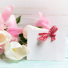 Postcard with fresh spring flowers and empty tag for your text