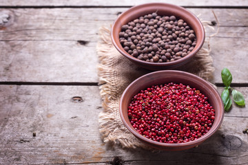 Obraz na płótnie Canvas Different pepper in bowls on wooden background