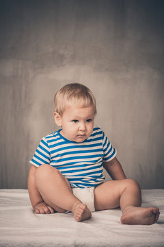 portrait of a boy in the studio on a gray background